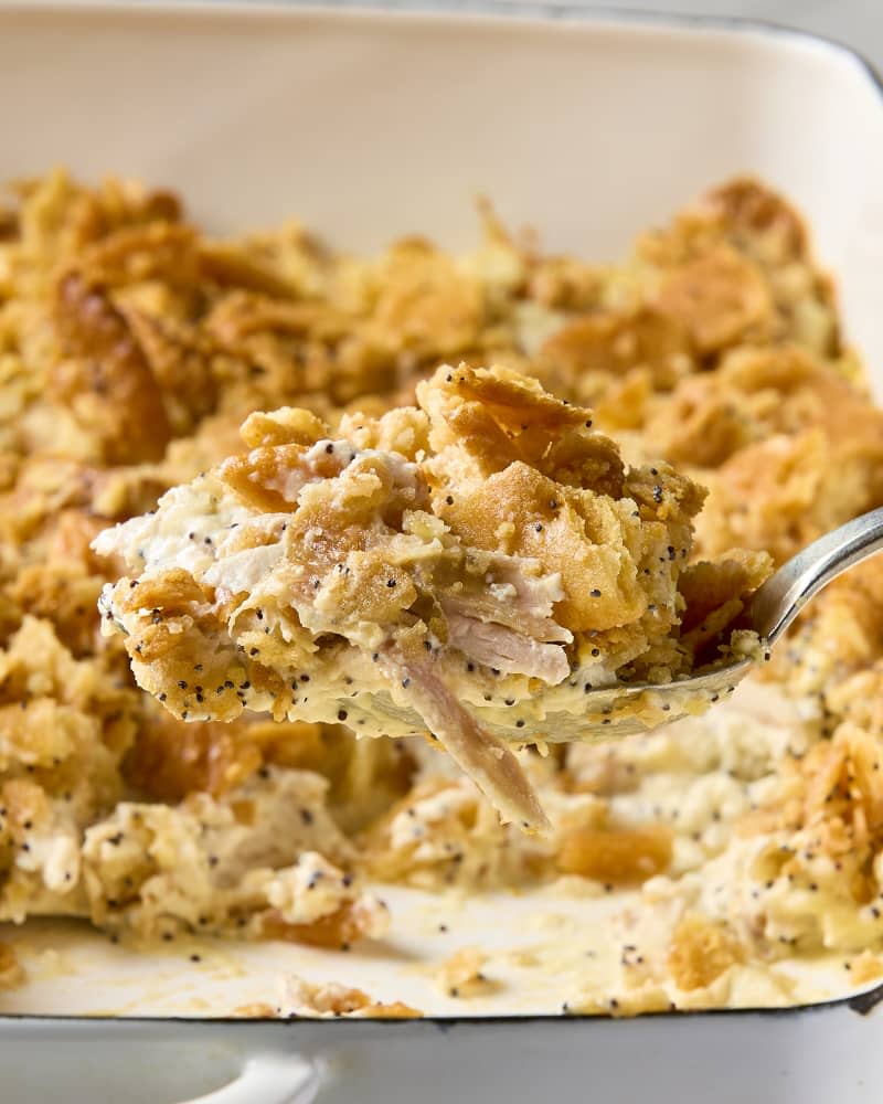 A close up view of a spoonful of poppyseed chicken casserole