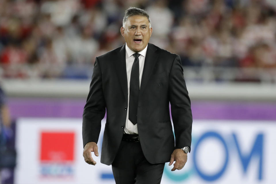 Japan coach Jamie Joseph watches as players warm up before the Rugby World Cup Pool A game at International Stadium between Japan and Scotland in Yokohama, Japan, Sunday, Oct. 13, 2019. (AP Photo/Jae Hong)