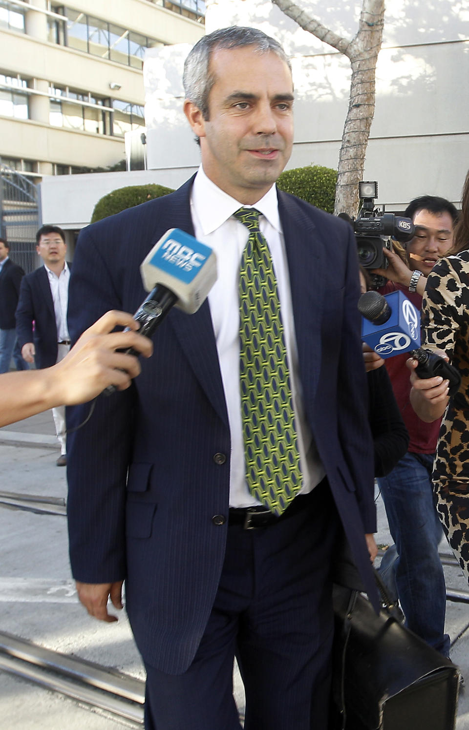 Kevin Johnson, attorney for Samsung, leaves the US Courthouse and Federal building after a jury reached a decision in the Apple Samsung trial on Friday, Aug 24, 2012 in San Jose, Calif. After a year of scorched-earth litigation, a jury decided Friday that Samsung ripped off the innovative technology used by Apple to create its revolutionary iPhone and iPad. The jury ordered Samsung to pay Apple $1.05 billion. An appeal is expected. (AP Photo/Tony Avelar)