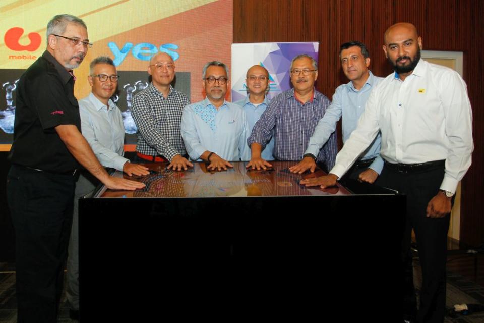 Malaysian Communications and Multimedia Commissions chairman Al-Ishsal Ishak (centre) poses for a group photo with telco CEOs in Putrajaya June 14, 2019. ― Picture by Yusof Mat Isa