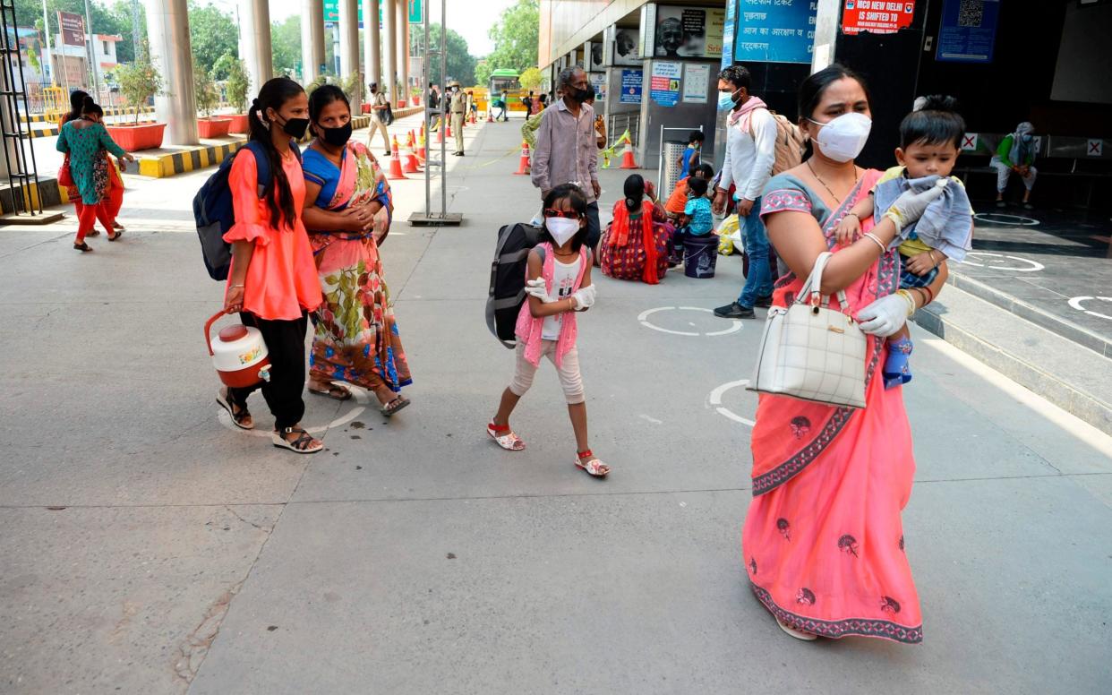 Passengers arrive at New Delhi railway station as lockdown travel restrictions are eased - Sajjad Hussain/AFP