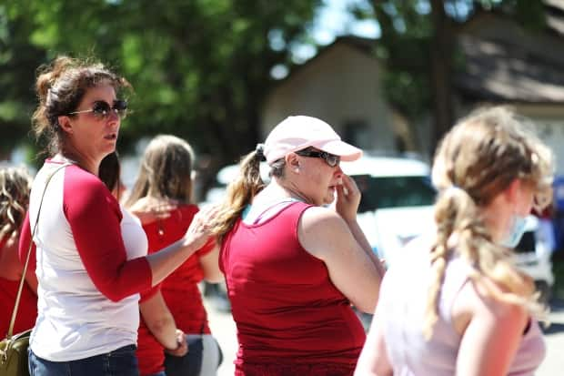 Community members came out for the procession of Const. Shelby Patton's body through Wolseley, Sask., on Tuesday, after the RCMP officer was killed on duty.  (Heidi Atter/CBC - image credit)