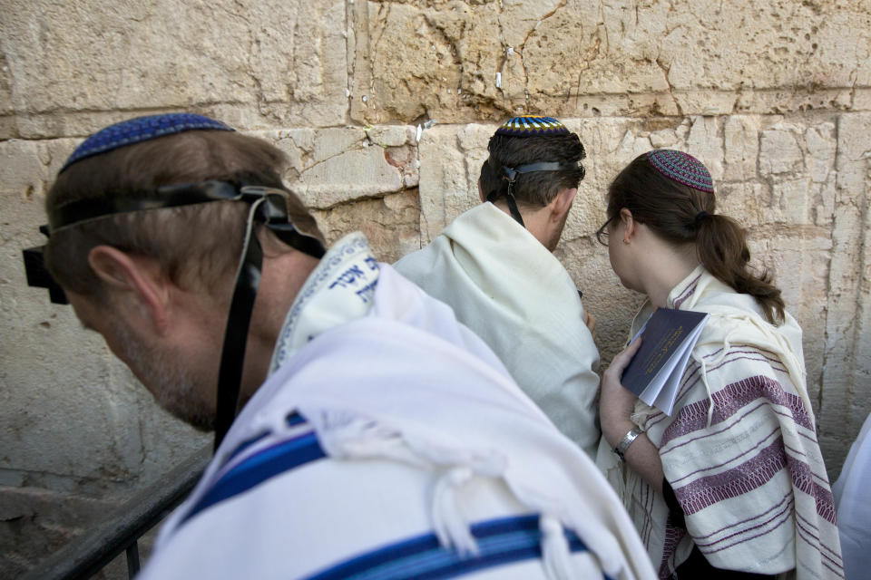 FILE - In this Thursday, Feb. 25, 2016 file photo, American and Israeli Reform rabbis pray at the Western Wall, the holiest site where Jews can pray in Jerusalem's old city. Israel's recent detentions of Jewish-American critics entering the country is shining a spotlight on a growing gulf between the country's hard-line government and the predominantly liberal Jewish community in the U.S. (AP Photo/Sebastian Scheiner, File)