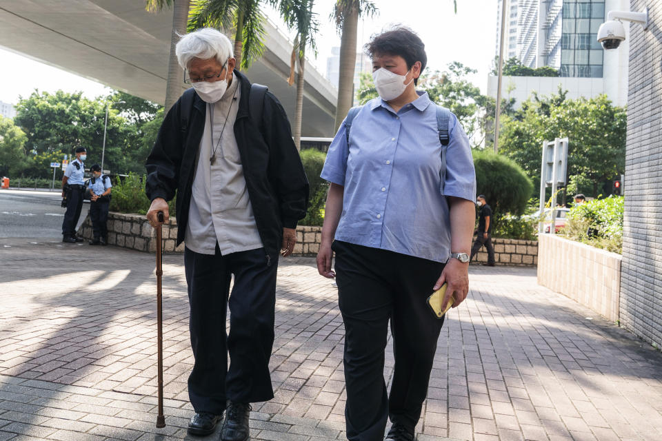 Cardinal Joseph Zen, left, arrives at the West Kowloon Magistrates' courts in Hong Kong on Monday, Sept. 26, 2022. The 90-year-old Catholic cardinal and five others stood trial in Hong Kong on Monday for allegedly failing to register a now-defunct fund set up to assist people arrested in the mass anti-government protests in the city three years ago. (AP Photo/Oiyan Chan)