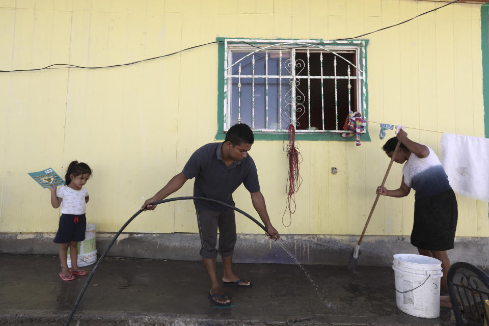 Central American migrants clean the Pan de Vida shelter for migrants in Ciudad Juarez, Mexico, where they are staying while waiting for a chance to request asylum in the United States, Thursday, Sept. 12, 2019. Mexican Foreign Secretary Marcelo Ebrard said Thursday that Mexico's government doesn't agree with an "astonishing" U.S. Supreme Court order that would block migrants from countries other than Mexico and Canada from applying for asylum at U.S. borders.(AP Photo/Christian Chavez)