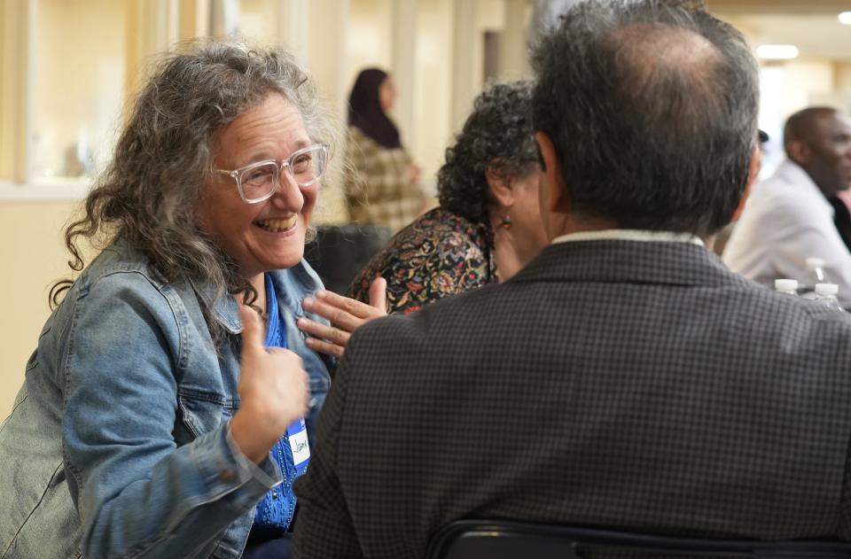 Participants talk during the Interfaith Iftar held Wednesday at the Noor Islamic Cultural Center in Hilliard.