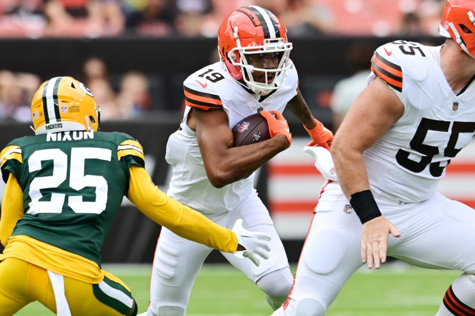 August 10, 2024; Cleveland, Ohio, USA; Cleveland Browns wide receiver Cedric Tillman (19) runs with the ball after a catch in the first quarter as Green Bay Packers cornerback Keisean Nixon (25) defends at Cleveland Browns Stadium. Mandatory Photo Credit: Ken Blaze-USA TODAY Sports