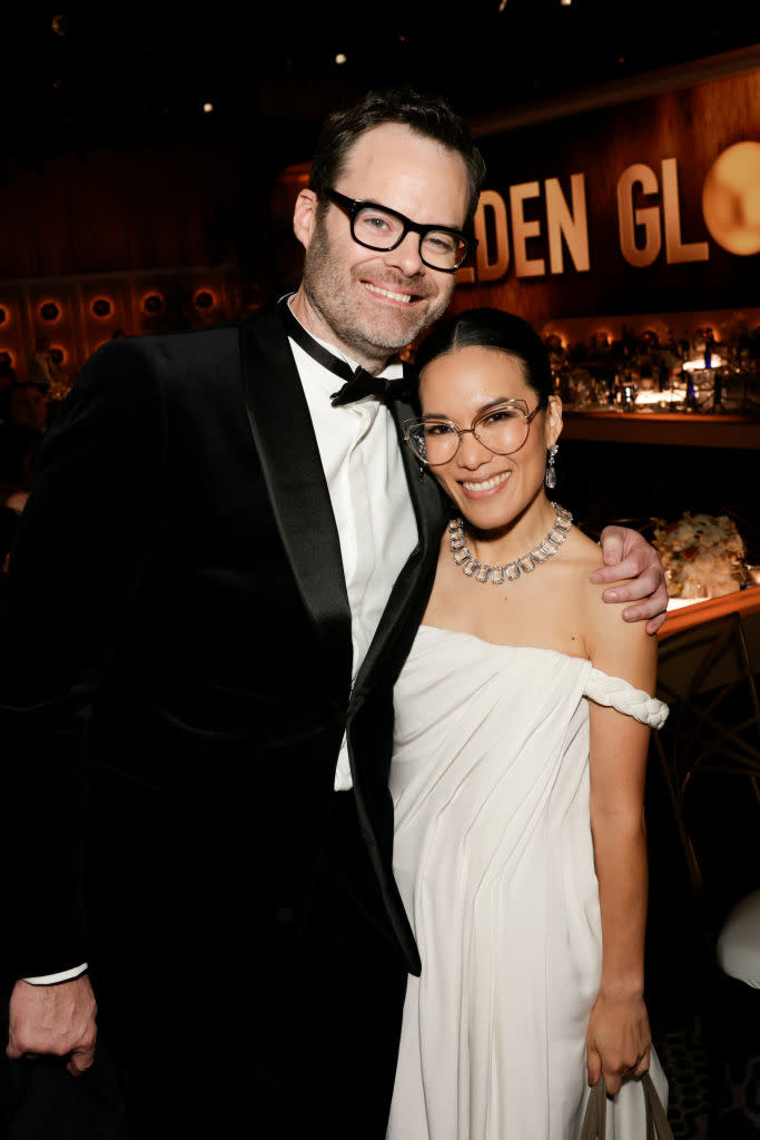 Bill Hader and Ali Wong posing together; he's in a tuxedo and she's in a gown with a necklace