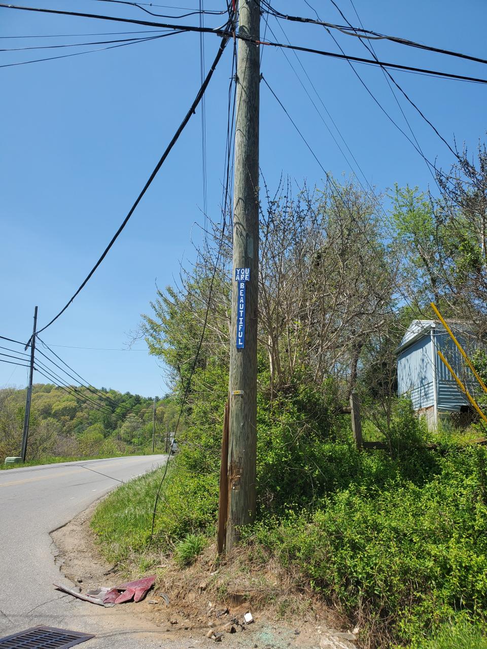 A sign at the corner of Woodfin Avenue and Riverside Drive in Woodfin reads, "You Are Beautiful."