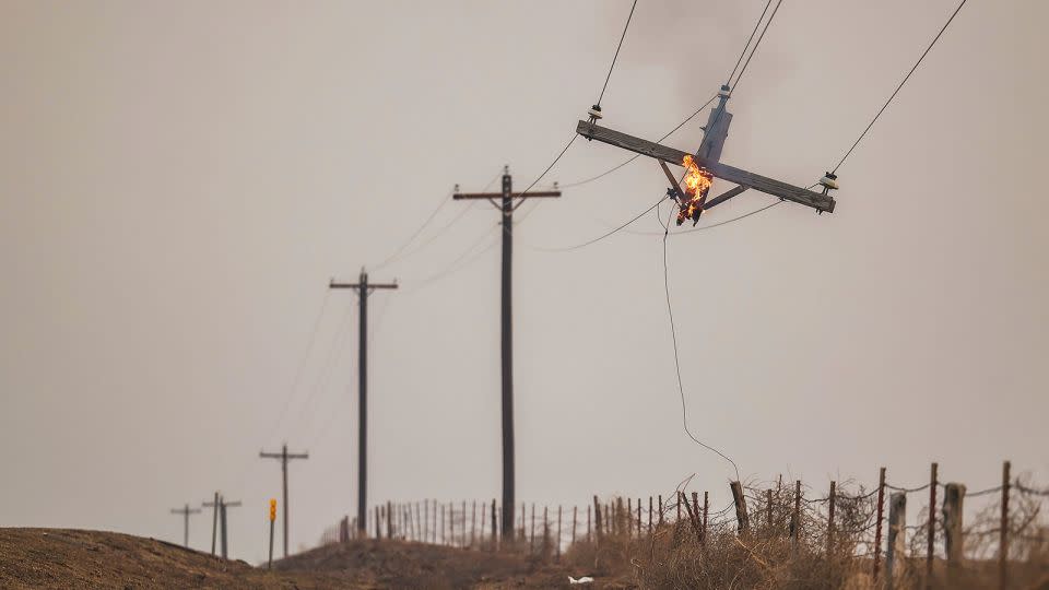 A telephone pole burns from the Smokehouse Creek Fire on Wednesday in Canadian, Texas. - David Erickson/AP