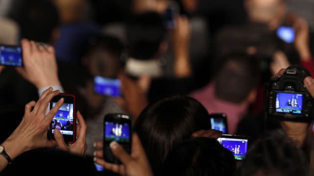 Cameras in audience follow U.S. President Barack Obama as he speaks to the employees of the EPA in Washington