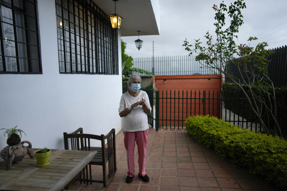 FILE - In this Oct. 1, 2021, file photo, Esperita García de Perez, 88, stands outside at her daughter's house in Caracas, Venezuela. She got her first vaccination against COVID-19 in May and she had hoped to get her second shot of the Russian-developed Sputnik V vaccine a few weeks later. But the 88-year-old is still waiting. (AP Photo/Ariana Cubillos, File)