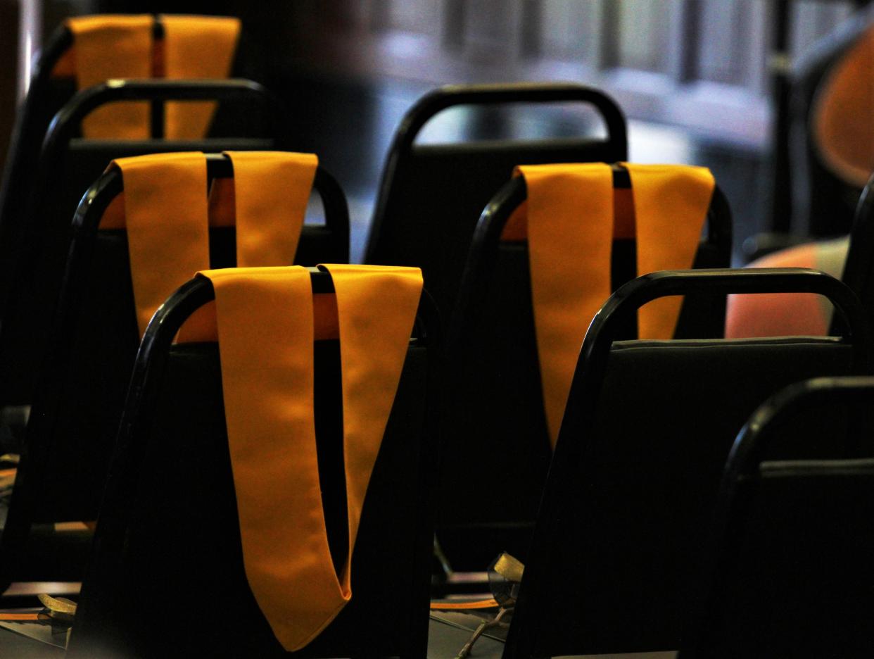Graduation sashes are seen laying on open chairs to represent the University of Missouri students who passed away in the past year on April 14, 2023, in the rotunda at Jesse Hall.