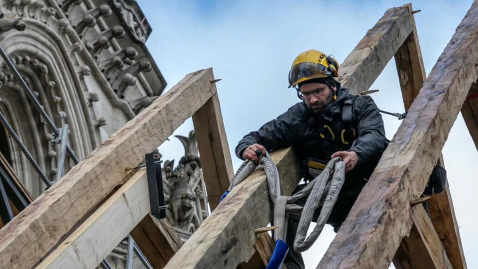 Hank Silver, a carpenter from Massachusetts, helps to reassemble roof trusses in the nave of Paris' Notre Dame cathedral. / Credit: Courtesy of Hank Silver