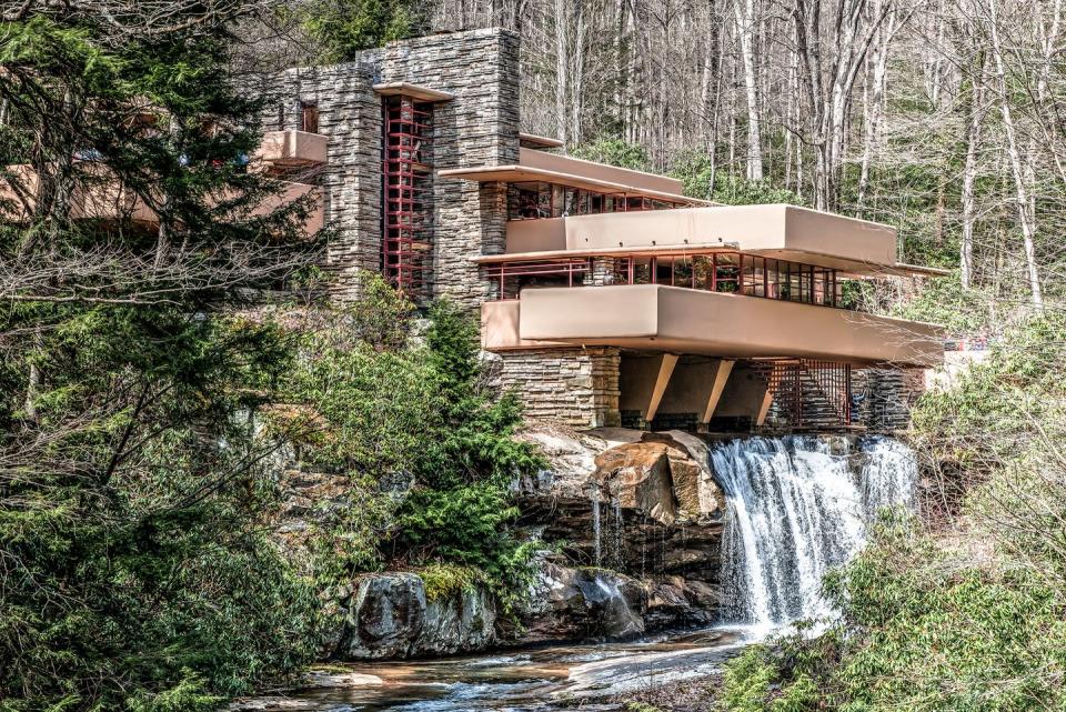 <p><a href="https://fallingwater.org/" rel="nofollow noopener" target="_blank" data-ylk="slk:Fallingwater;elm:context_link;itc:0;sec:content-canvas" class="link ">Fallingwater </a>stands as one of iconic architect Frank Lloyd Wright’s most celebrated projects for its innate connection to nature and forward-thinking design. The extraordinary house in Mill Run, Pennsylvania, served as the weekend getaway for the Kaufmann family, who originally envisioned it to be placed across from the waterfall. </p><p>Wright, inspired by traditional Japanese architecture, instead drew up plans for the house to be over the waterfall and positioned to look as though it was one with the natural rock formations. In 1976, the home was named a National Historic Landmark, and it remains one of the most popular destinations for architectural lovers in the world.</p>