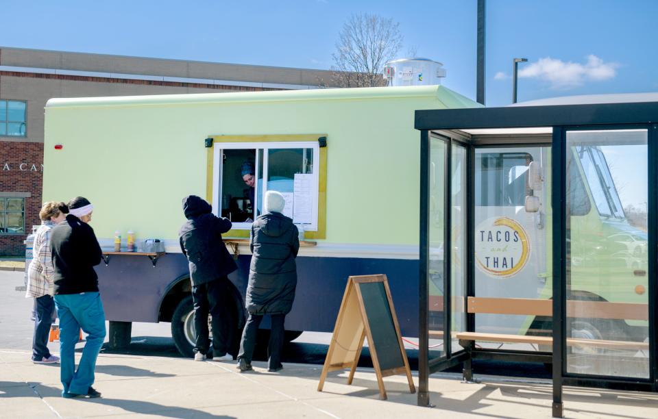 The Tacos and Thai food truck draws a steady crowd of hungry customers during a lunchtime visit in the parking lot of Illinois CancerCare off Route 91 in North Peoria.