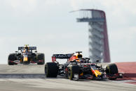Red Bull driver Max Verstappen, of the Netherlands, right, and Red Bull driver Sergio Perez, of Mexico, left, steer through a turn during an open practice for the Formula One U.S. Grand Prix auto race at Circuit of the Americas, Friday, Oct. 22, 2021, in Austin, Texas. (AP Photo/Eric Gay)