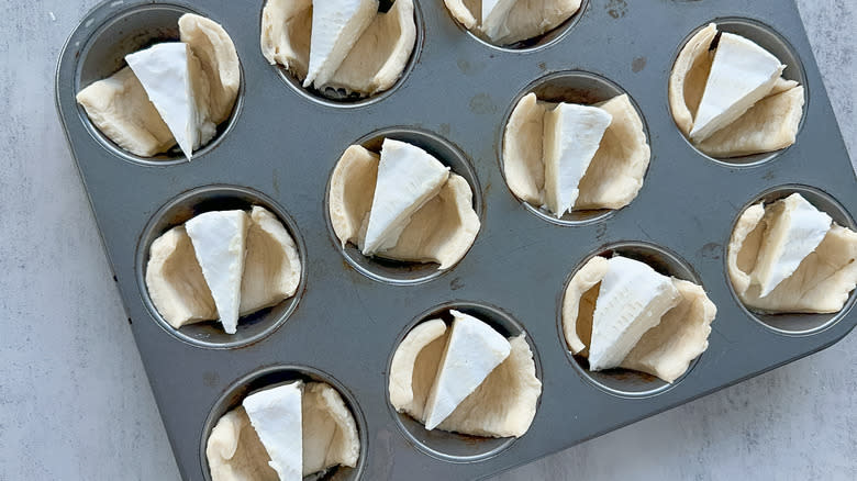 brie on dough in muffin tins