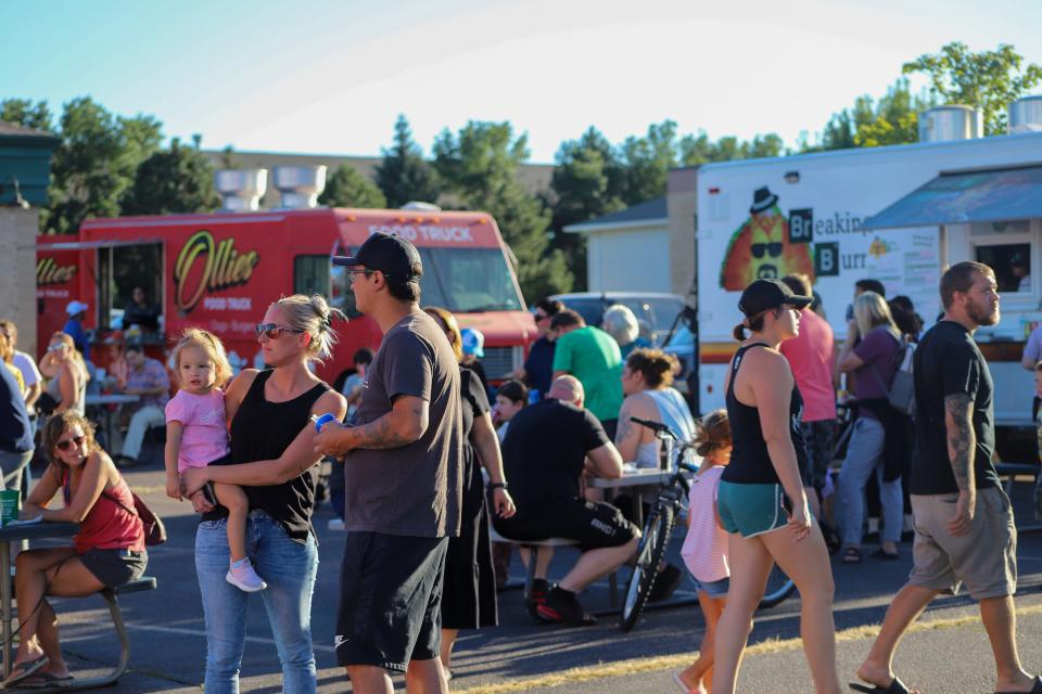 Multiple food trucks come out to Golf Addiction on Tuesdays during the summer in Sioux Falls, drawing in a crowd of people on August 30.