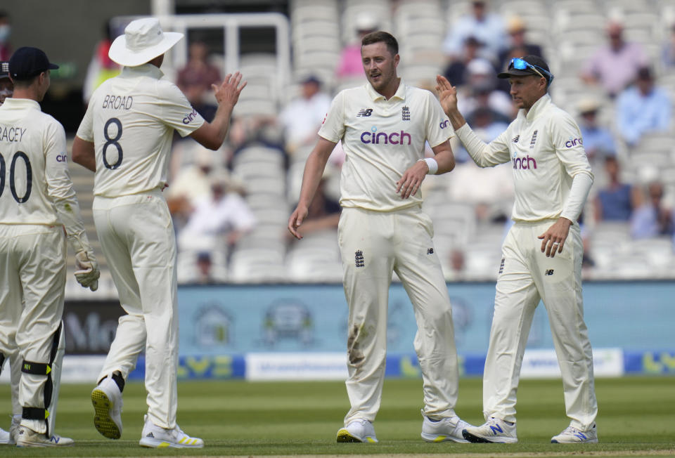 England's Ollie Robinson, centre, celebrates taking the wicket of New Zealand's Ross Taylor during the first day of the Test match between England and New Zealand at Lord's cricket ground in London, Wednesday, June 2, 2021. (AP Photo/Kirsty Wigglesworth)