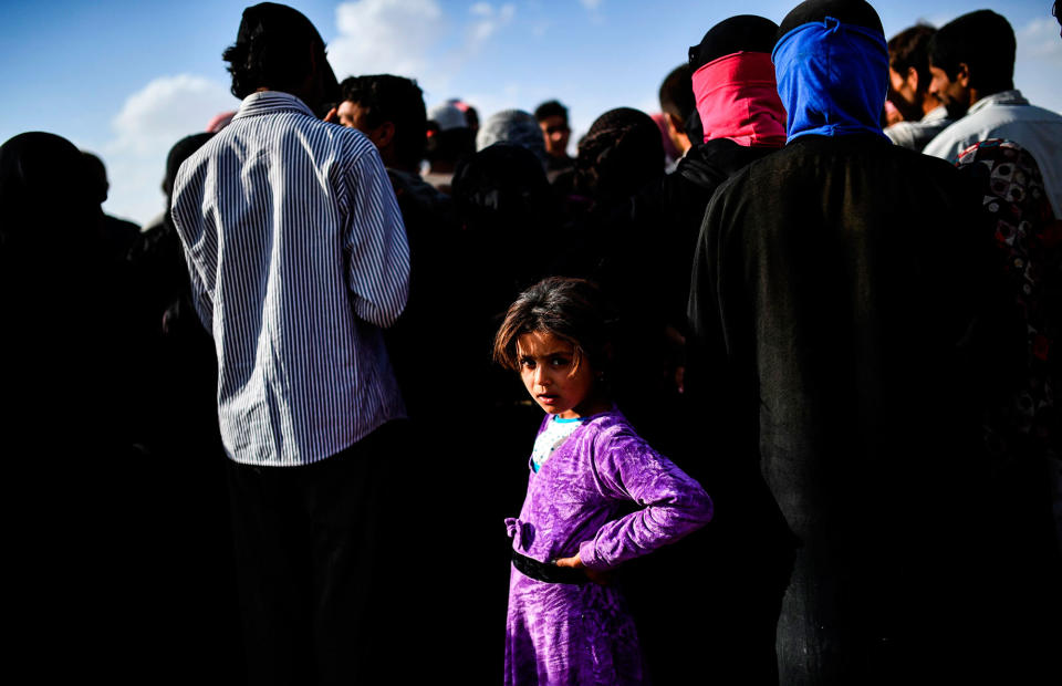 <p>Syrians displaced from the city of Deir Ezzor wait for to get bread on the outskirts of Raqa on Oct. 2, 2017.<br> Syrian fighters backed by U.S. special forces are battling to clear the last remaining Islamic State group jihadists holed up in their crumbling stronghold of Raqqa. (Photo: Bulent Kilic/AFP/Getty Images) </p>