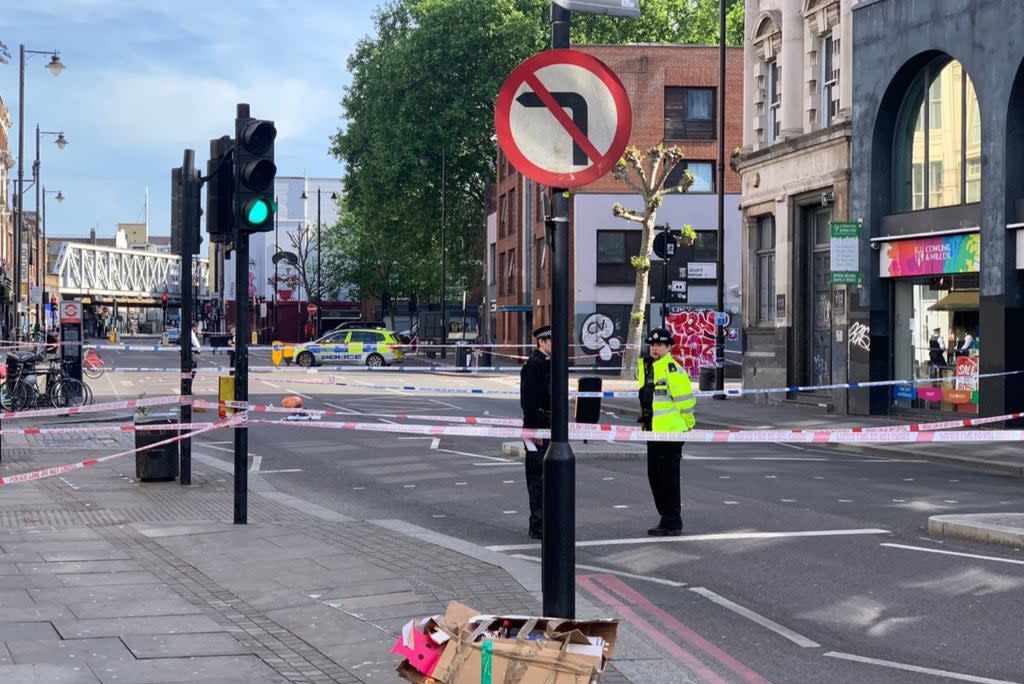 Officers at the scene following a fight in Shoreditch  (Lachlan Cartwright )