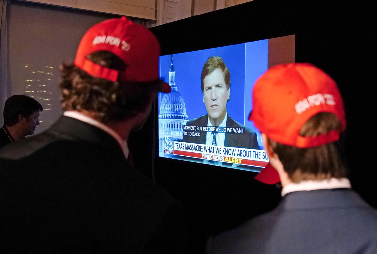 People watch Tucker Carlson during an election night watch party in Atlanta (Brynn Anderson / AP)