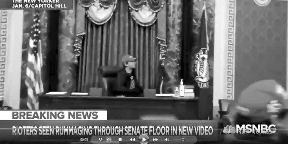 Christian Secor sits in Mike Pence's seat in the Senate on January 6, 2021.