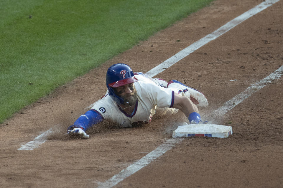 PHILADELPHIA, PA - APRIL 07: Bryce Harper #3 of the Philadelphia Phillies slides in safely at first base for a bunt single in the bottom of the fifth inning against the New York Mets at Citizens Bank Park on April 7, 2021 in Philadelphia, Pennsylvania. The Phillies defeated the Mets 8-2. (Photo by Mitchell Leff/Getty Images)