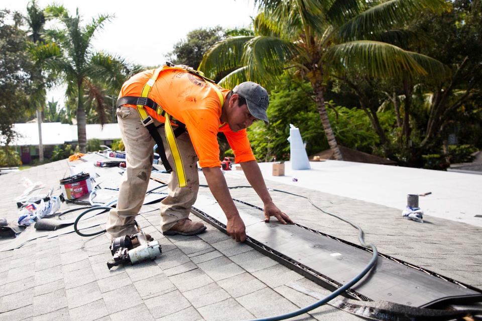 Vogel Construction Group roofer Jeronimo Oxlaj works on Bravo House on Wednesday, Nov. 3, 2021 in Naples, Fla. Vogel Construction Group's owners Hannah Vogel and James Hartney, fixed the roof of the Bravo House through a grant from the Home Depot Foundation. The Bravo House accommodates veterans who are are homeless or at risk of becoming homeless in Collier County.