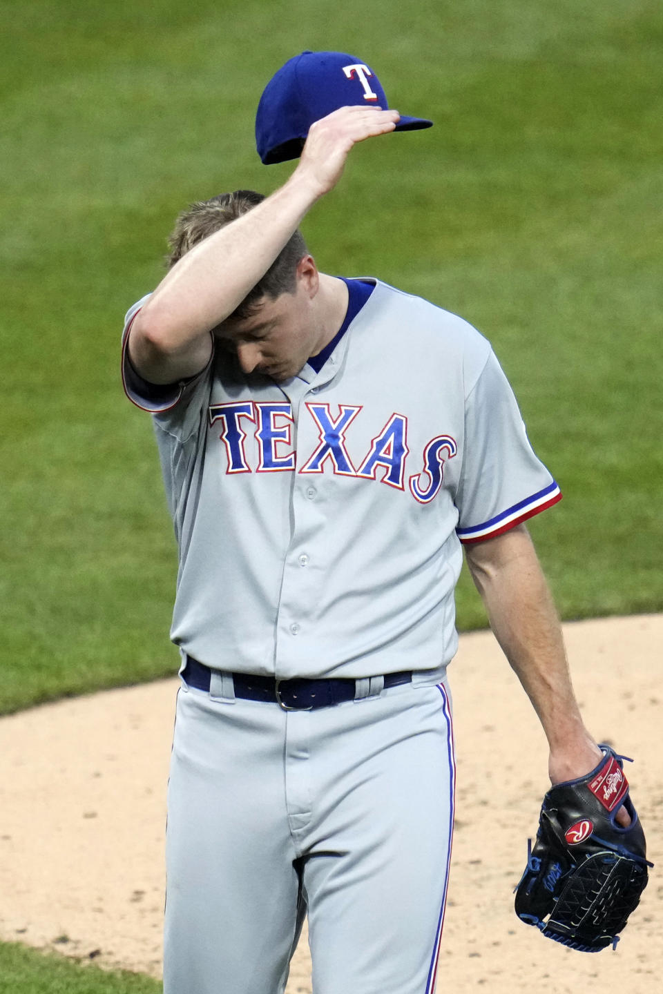 Texas Rangers relief pitcher Josh Sporz walks off the field after being pulled in the seventh inning of a baseball game against the Pittsburgh Pirates in Pittsburgh, Monday, May 22, 2023. (AP Photo/Gene J. Puskar)