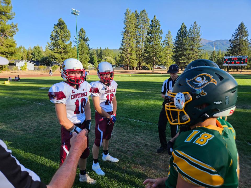 Big Valley senior captains Kade Lemke and Marcus Mitchell (left) meet with Burney captains senior Alonzo Mercado and junior Kyle Noah (right) for the coin toss before the Fair Bowl on Wednesday, Aug. 30, 2023.