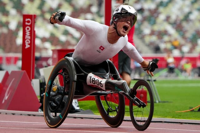 Marcel Hug celebrates after winning the men's T54 1500m final 