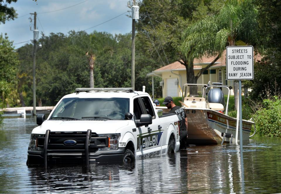 In this 2021 file photo, Firefighters from East Manatee assist North Port Police with their shallow-draft boat to check water levels in neighborhoods off Sumter Blvd., north of I-75. Streets near the Myakkahatchee Creek in North Port were flooded as rain from Tropical Storm Elsa continued to drain.