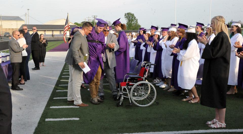 After receiving his diploma, Triway Local graduating senior Christian Mendoza is greeted with a standing ovation by the entire stadium as he makes his way back to his seat.