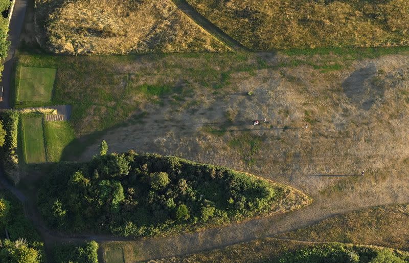 Golfers play on a parched course as seen from a balloon at the annual Bristol International Balloon Fiesta, near Bristol