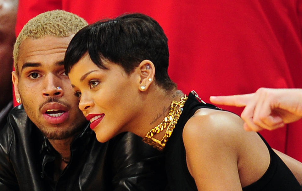 Rihanna and Chris Brown attend a game between the New York Knicks and the Los Angeles Lakers during the NBA game at Staples Center in Los Angeles, California, on December 25, 2012.