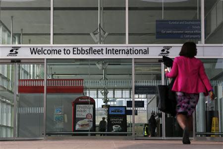 A woman enters Ebbsfleet International Station in Ebbsfleet, southern England March 27, 2014. Under a new government-backed plan, more than 20,000 new homes will be built in Ebbsfleet, 20 miles east of London and just 17 minutes from the centre of the capital on a high-speed rail line. Picture taken on March 27, 2014. To match Analysis BRITAIN-HOUSING/ REUTERS/Stefan Wermuth