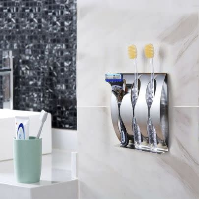 Neatly organise your toothbrushes and razors with this self-adhesive wall caddy.