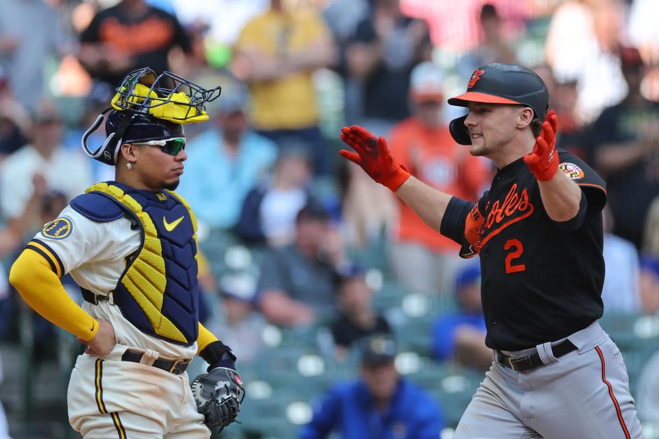 Gunnar Henderson of the Baltimore Orioles celebrates a 2-run home run in front of Brewers catcher William Contreras during the eighth inning Thursday at American Family Field. Henderson's homer gave the Orioles a 4-3 lead in the 6-3 victory.