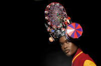 A model wears a design from the Philip Treacy Spring/Summer 2013 collection during London Fashion Week, Sunday, Sept. 16, 2012. (AP Photo/Jonathan Short)