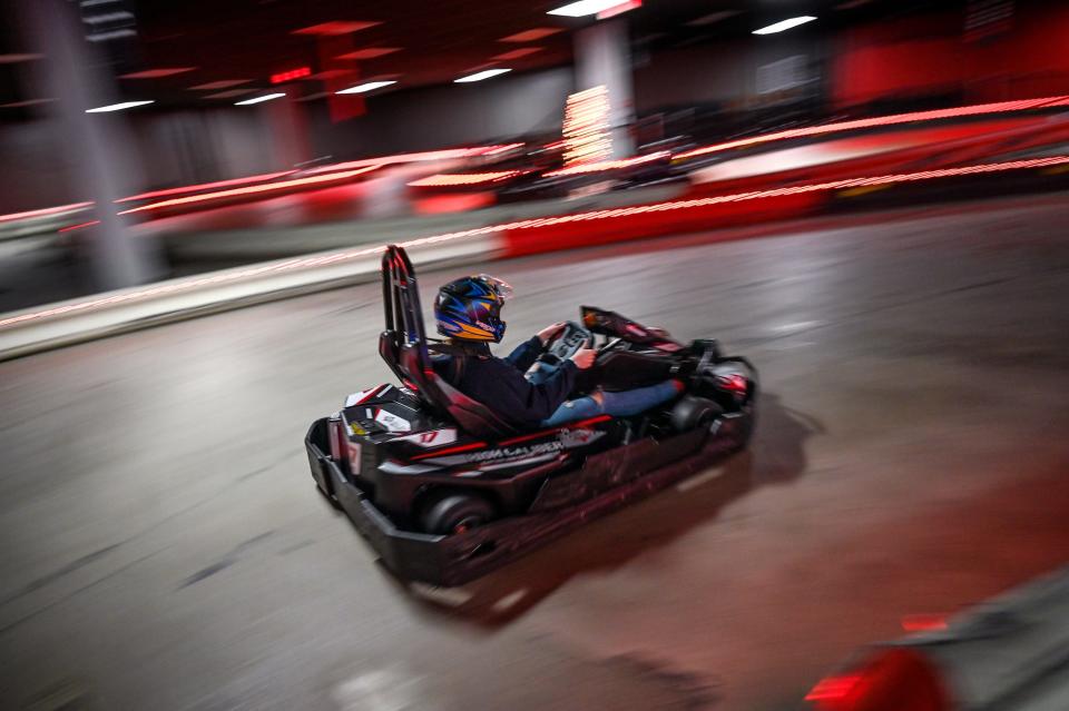 A racer speeds around the go-kart track at High Caliber Karting and Entertainment on Wednesday, Nov. 29, 2022, at the Meridian Mall in Okemos.