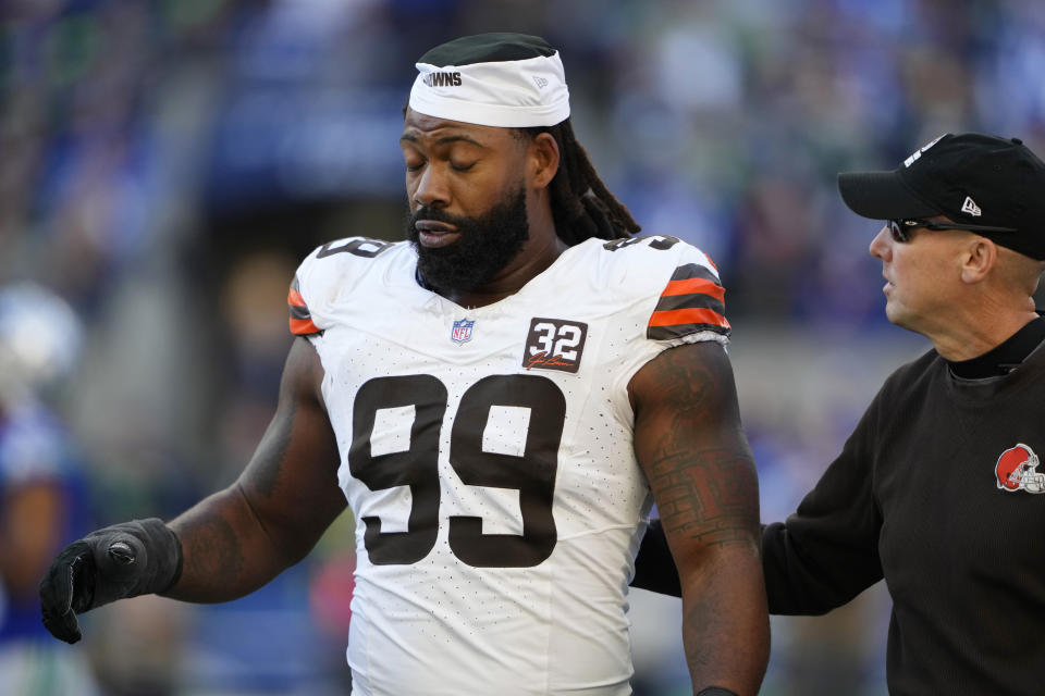 Cleveland Browns defensive end Za'Darius Smith (99) its helped off the field in the second half of an NFL football game against the Seattle Seahawks, Sunday, Oct. 29, 2023, in Seattle. (AP Photo/Lindsey Wasson)