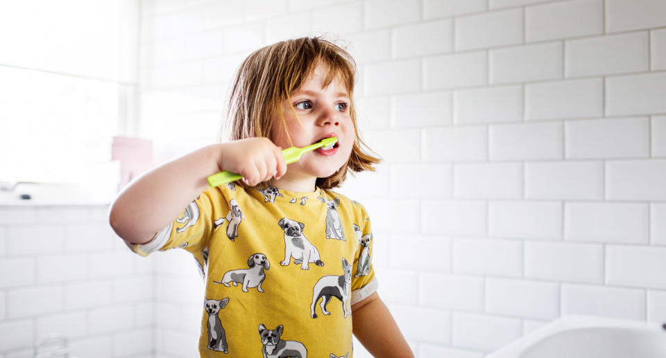 Child with toothbrush. 