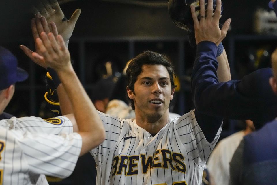 Milwaukee Brewers' Christian Yelich is congratulated after hitting a home run during the sixth inning of a baseball game against the Kansas City Royals Saturday, May 13, 2023, in Milwaukee. (AP Photo/Morry Gash)