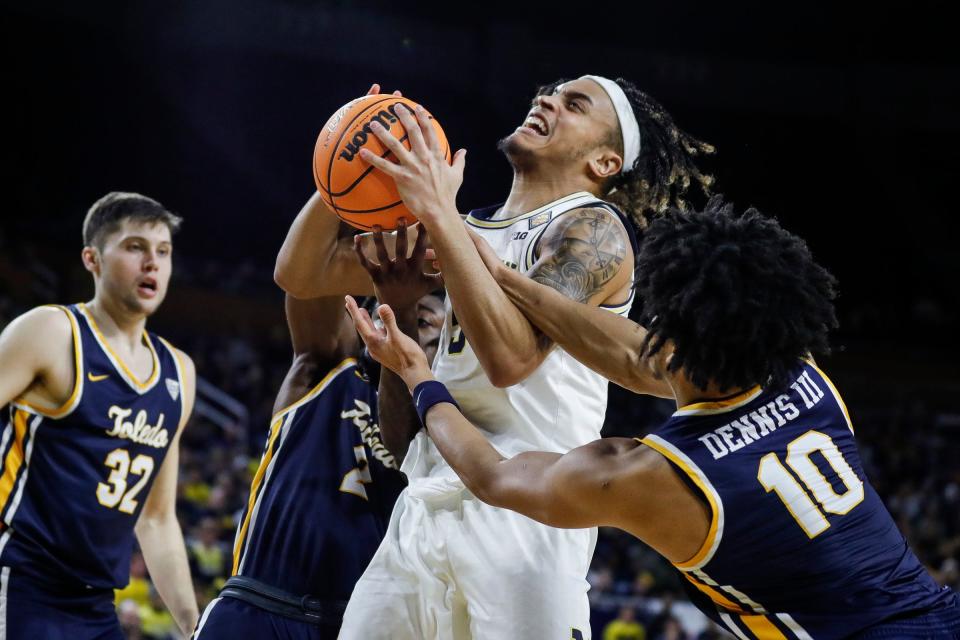 Michigan forward Terrance Williams II (5) is defended by Toledo guard RayJ Dennis (10) and guard E.J. Farmer (2) during the second half of the first round of the NIT at Crisler Center in Ann Arbor on Tuesday, March 14, 2023.