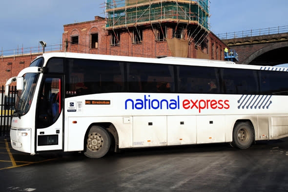 A National Express coach at a National Express bus Depot in Digbeth, Birmingham. The Train and bus operator said today that it planned to cut up to 750 jobs in a bid to save 15 million a year. 