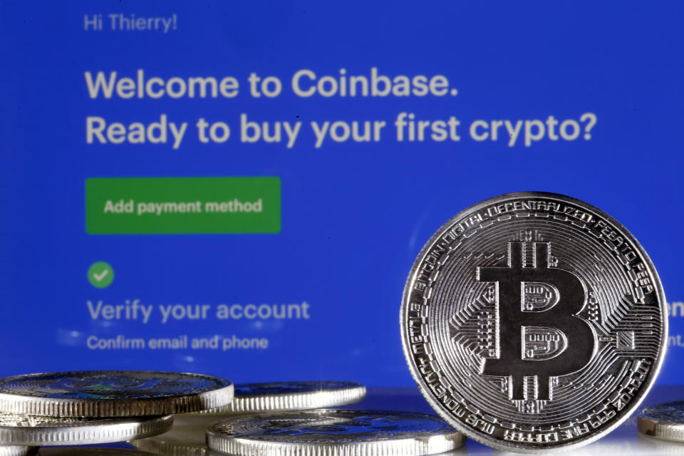 PARIS, FRANCE - FEBRUARY 26: In this photo illustration, a visual representation of the digital Cryptocurrency, Bitcoin is displayed in front of the Coinbase cryptocurrency exchange website on February 26, 2021 in Paris, France. Cryptocurrency trading platform Coinbase has filed for registration with the SEC on Thursday for an IPO via direct listing on the Nasdaq and will likely be the largest IPO of the year. Coinbase reported $ 1.28 billion in revenue in 2020 (+ 140% year on year), for net profit of $ 320 million. (Photo illustration by Chesnot/Getty Images)