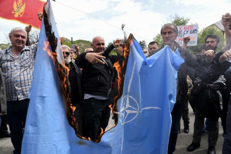 Protesters burn the NATO flag on April 28 during a demonstration against  Montenegro's accession to the Western military bloc