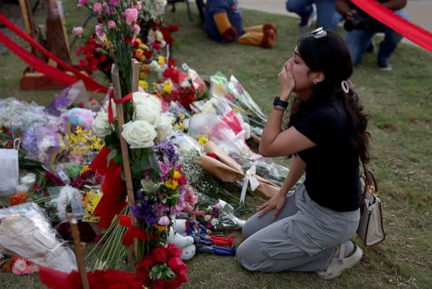 PHOTO: Citaly Ramirez reacts as she visits a memorial setup near an entrance to the Allen Premium Outlets, May 8, 2023, in Allen, Texas. (Joe Raedle/Getty Images)